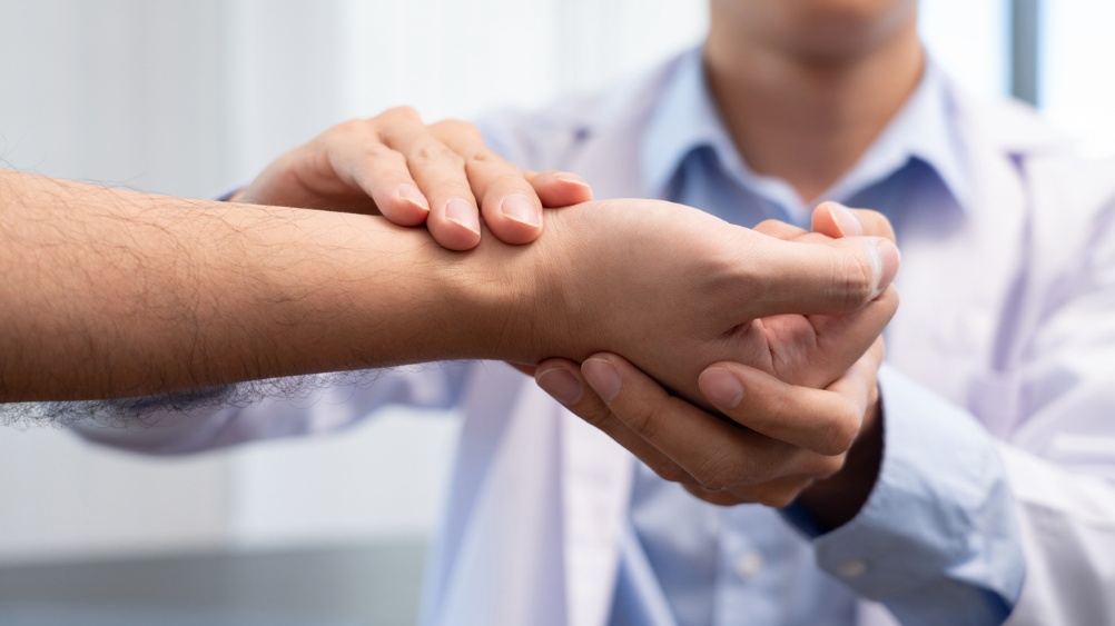 Carpel Tunnel Relief, A doctor holding a persons hand