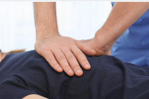 a person applying a chiropractic procedure to another happy smiling person lying down, Top 10 Chiropractic Care FAQs: Empowering You to Make the Best Choices for Your Health