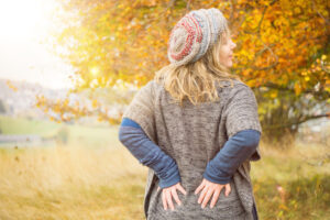 Chiropractic Care for Fall: Relieve Seasonal Aches and Strains, A person holding their back