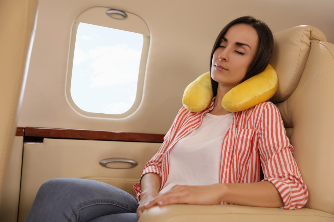 a person using a neck brace while flying, holiday survival tips for a healthy spine