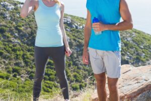 Two people outdoors holding/drinking water, Water and Your Spinal Health