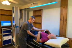 Dr. Craig Strickland providing spinal decompression therapy using the FDA-approved Accu-Spina® system at Carolina Rehab & Physical Medicine Center.