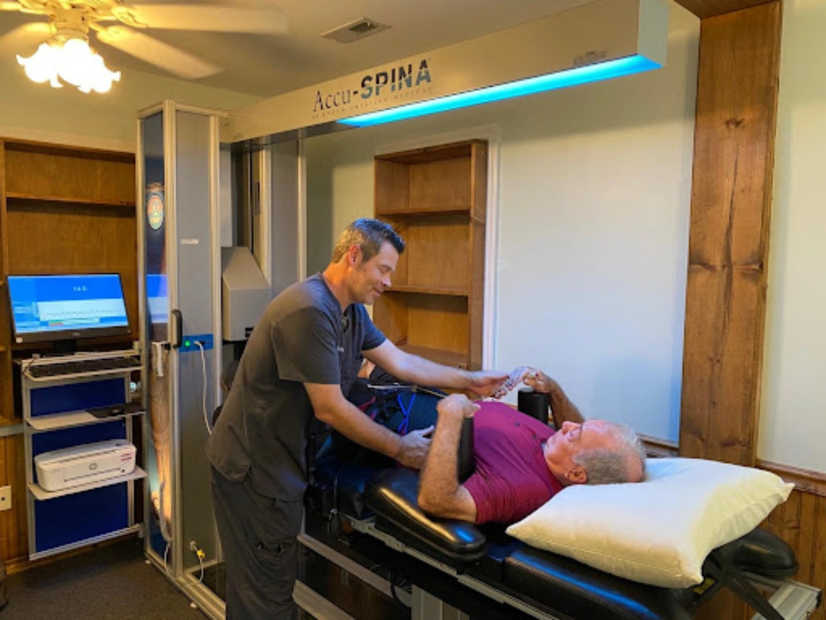 Dr. Craig Strickland providing spinal decompression therapy using the FDA-approved Accu-Spina® system at Carolina Rehab & Physical Medicine Center.
