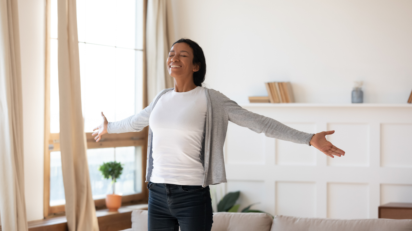 A picture of a person stretching while smiling, Holiday wellness tips