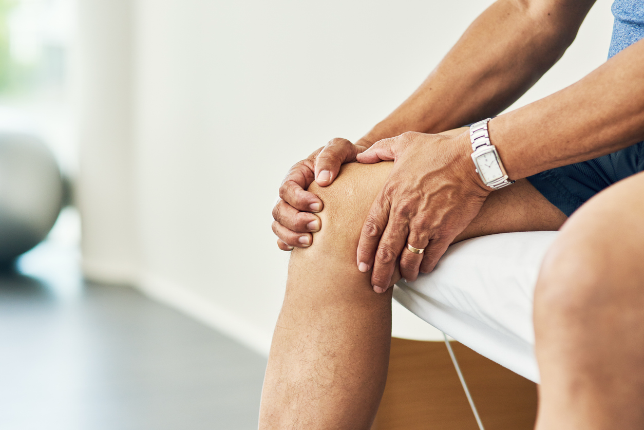 man holding his knee